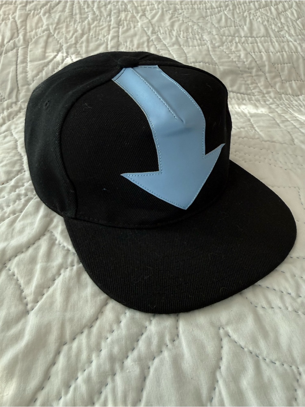 Black Snapback Hat with Light Blue Arrow Accent